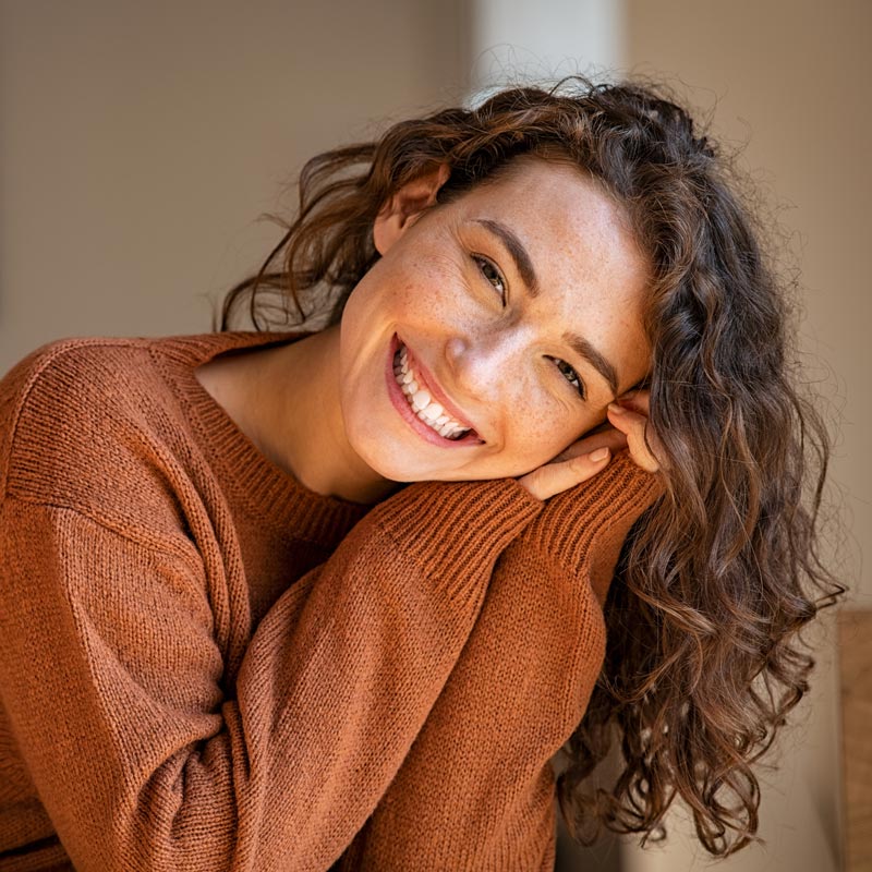 Young woman laughing while relaxing at home